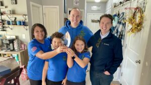 The ZehmTV family celebrating at home with their Better Business Bureau award trophy after receiving recognition for business excellence